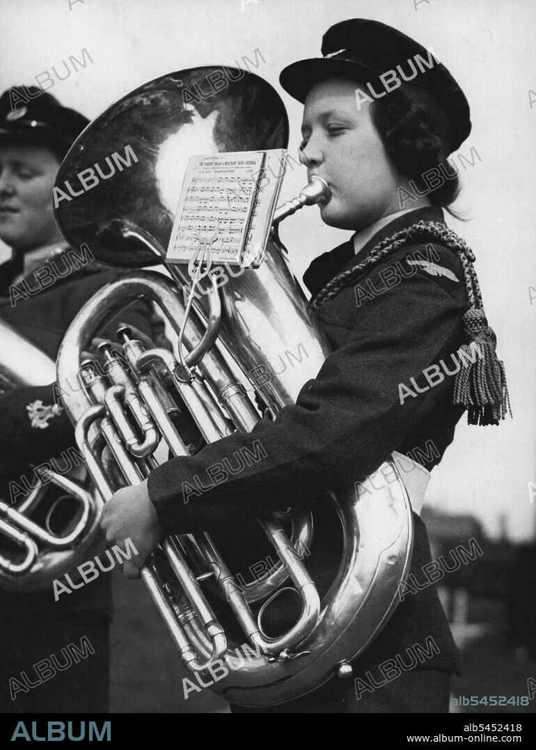 Wraf's Big Blow - Aircraftswoman Doreen Andrew of Neither Wallop practising on a massive bass at Hanlow to-day.A new and enlarged band of the women's Royal Air Fore is in rehearsal at the Royal Air Force Station, Henlow, Bedforshire.The Service now has, for the first tire, a full brass band, and it is hoped that by the end of the year, perhaps sooner, the players will be ready for their first public performance. Some of the girls - the oldest is 23 - were unable to play a rote of music until three months ago. April 05, 1949. (Photo by Reuterphoto).