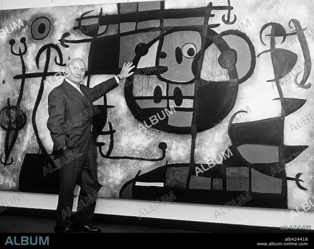 JOAN MIRÓ. Joan Miró standing before his painting "Circus Horse" 1966.