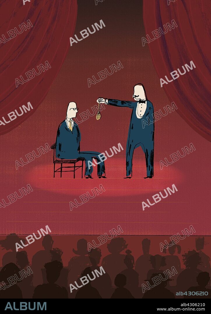 Audience watching businessman being hypnotized on stage.