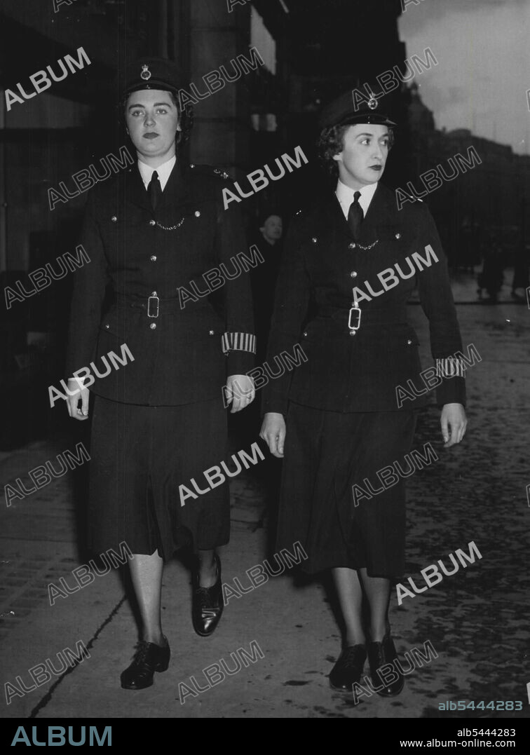 The Women in Blue Two trim waisted policewomen on duty in Regent Street, London, last night. Unobtrusive make-up. Not a hair out of place, Policewoman C383 on the left, has blue eyes. Her companion - C122 - has eyes of brown. Both are brunettes. Britain's women police were praised, yesterday, in the House of Commons by Mrs. Lena Jeger, M.P. She said that the last two years no member of the Metropolitan woman's Police Force has been dismissed for misconduct, ill health or inefficiency. She emphasised that women police are not big women, taking size 12 in shoes and doing heavy footed, heavy handed work. May 7, 1954. (Photo by Daily Express Picture).