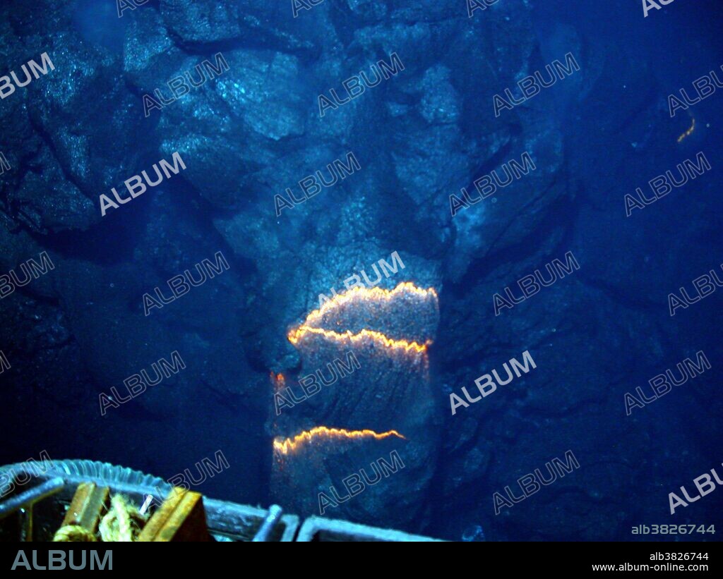 The West Mata volcano was discovered in May 2009 nearly 4,000 feet below the surface of the Pacific Ocean, in an area bounded by Fiji, Tonga and Samoa. It is the deepest erupting volcano discovered to date. In this image, bands of glowing magma, about 2,200 degrees Fahrenheit, are exposed as a pillow lava tube extrudes down slope. Image is about three feet across in an eruptive area about 100 yards that runs along the summit of the volcano.