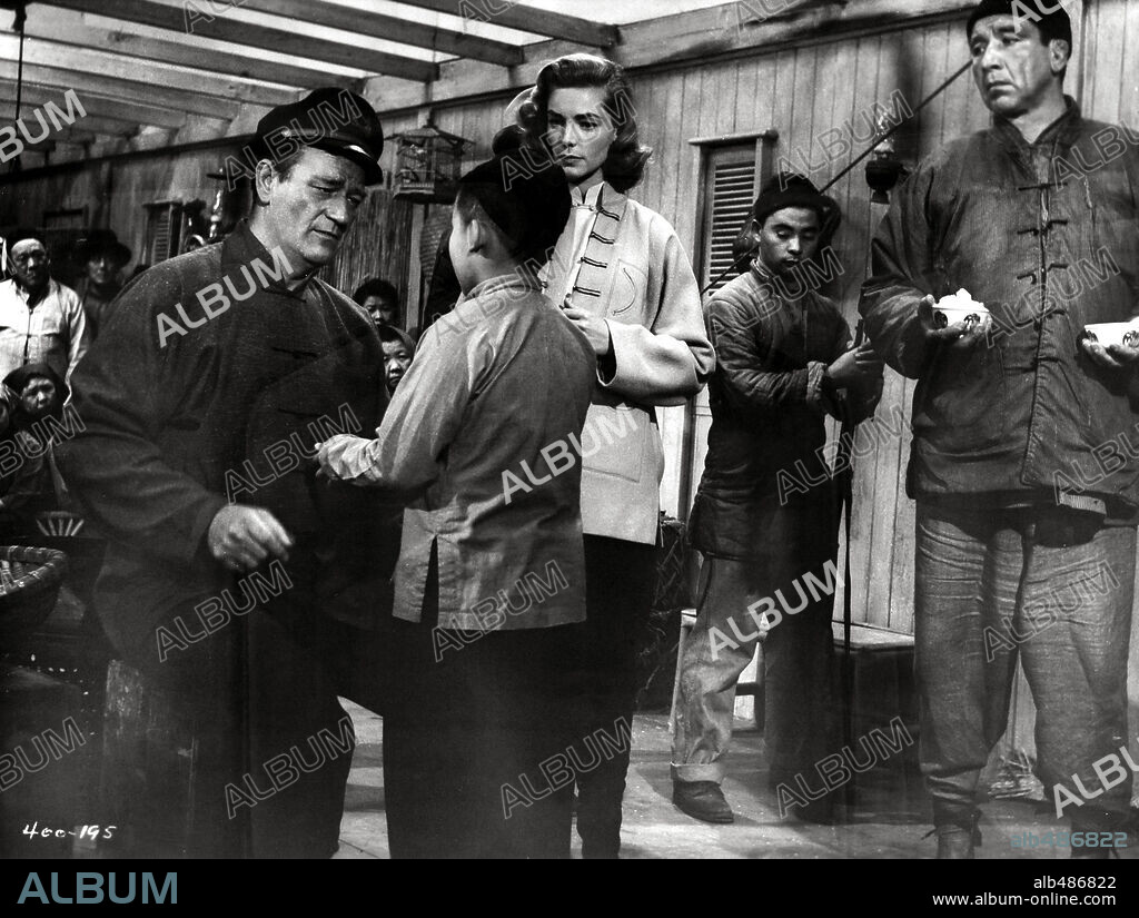 JOHN WAYNE and LAUREN BACALL in BLOOD ALLEY, 1955, directed by WILLIAM A. WELLMAN. Copyright WARNER BROTHERS.