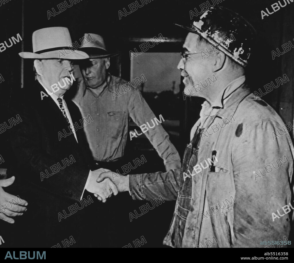 John L. Meets Brother Howard Lewis (right), employs of Old Ben No. 8 Coal Corp., meets his brother, John L. Lewis, (left), UMW President, as John L. visited scene of blast fatal to 27, today. In background in George Campbell, general manager of the mine. July 25, 1947. (Photo by AP Wirephoto).