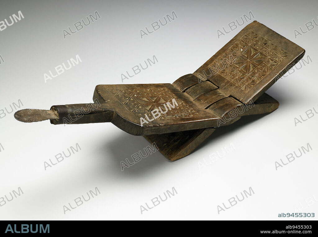 Coconut-grater stool, mid 20th century, 7 1/16 x 22 x 5 3/4 in. (17.94 x 55.88 x 14.61 cm) (unfolded), Wood, metal, Tanzania, 20th century, Youd be hard-pressed to identify this mysterious, almost dangerous-looking objectunless youre familiar with coconut grating along the Swahili coast of East Africa. Then its fairly straightforward: you sit on the stool and scrape the inside of an opened coconut on the protruding metal blade. The coconut shavings are collected and later pushed through a sieve to make coconut milk. The X-shape of the stool resembles a Quran stand, while the geometric designs show both Arab and Indian influences on Swahili culture.