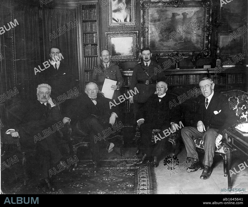 Council of Four at the Versailles Peace Conference 1918. Left to right: Vittorio Emmanuele Orlando, Prime Minister of Italy: David Lloyd George, Prime Minister of Britain: Georges Clemenceau, Prime Minister of France, and (Thomas) Woodrow Wilson, President of the USA. Standing are confidential secretaries.
