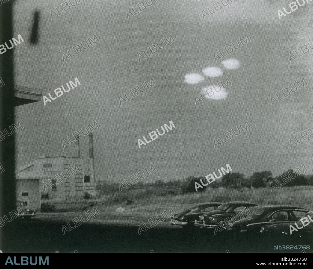 On July 16, 1952 at 09:35 AM Coast Guard seaman Shell Alpert, took this picture of four roughly elliptical blobs of light in formation through the window of his photographic laboratory. The objects were also witnessed by Coastguardsman Thomas Flaherty. Both were assigned to the base in nearby Salem, Massachusetts. The first analysis by US Air Force's Project Blue Book concluded it was probably a double exposure hoax. A second analysis by Blue Book concluded that it was probably reflections of street lamps on a window. Finally, the case was considered unexplained by Project Blue Book.