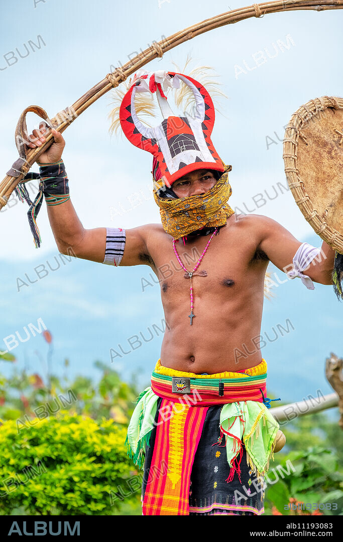 Caci man performing a traditional whip dance with bamboo shield and leather whip, western Flores, Indonesia, Southeast Asia, Asia.