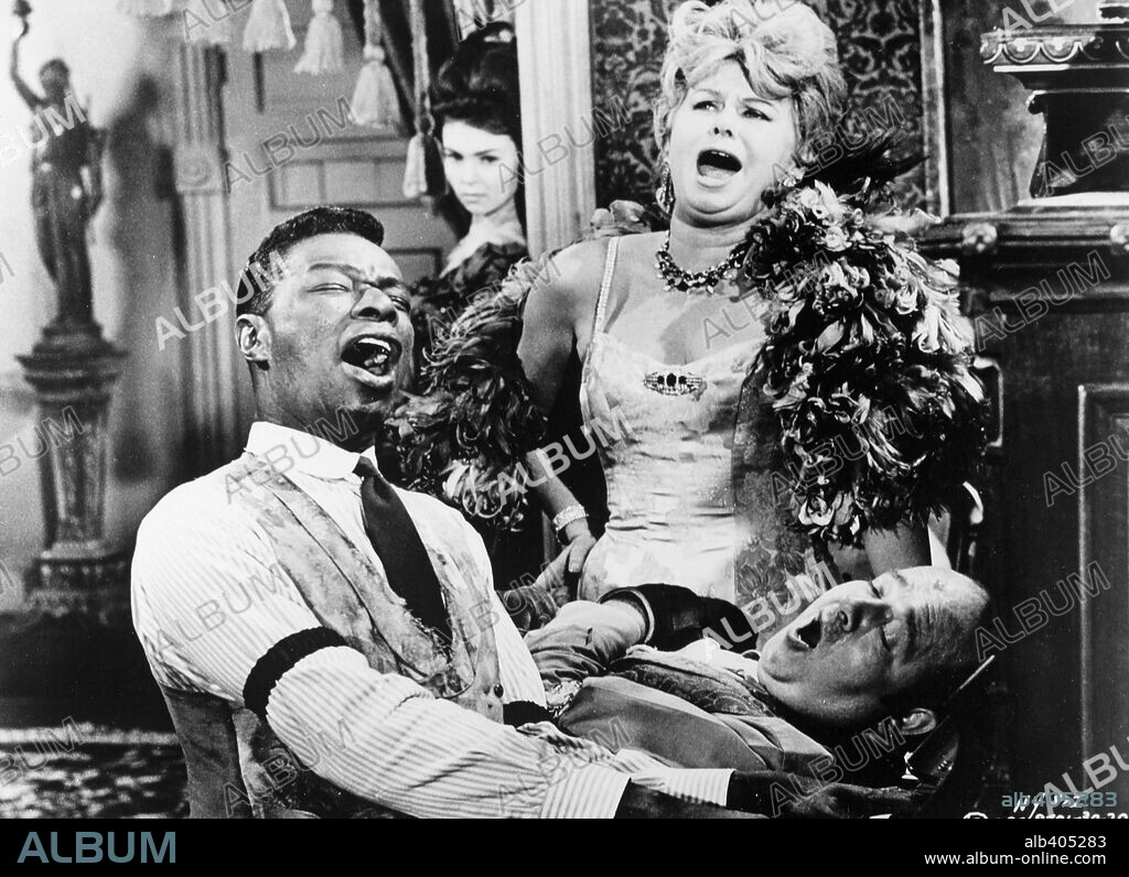 NAT KING COLE and STUBBY KAYE in CAT BALLOU, 1965, directed by ELLIOT SILVERSTEIN. Copyright COLUMBIA PICTURES.