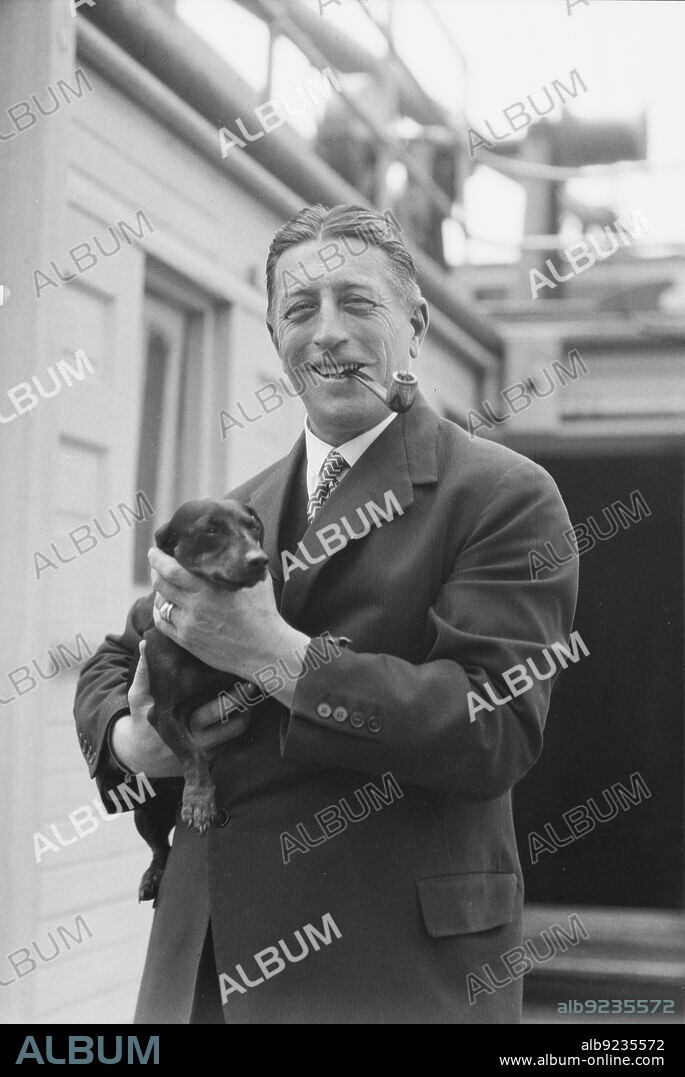 ARNOLD GENTHE. Von Lueckner, Felix, Count, with dog, standing outdoors, 1931 June 5.