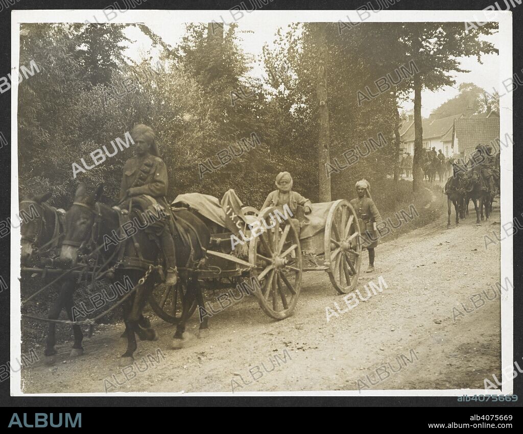 H. D GIRDWOOD. Baggage etc of a Cavalry Brigade on the march [near Fenges, France]. Troops of 36th Jacob's Horse moving through a French village. 1 August 1915. Record of the Indian Army in Europe during the First World War. 20th century, 1915. Gelatin silver prints. Source: Photo 24/(211).