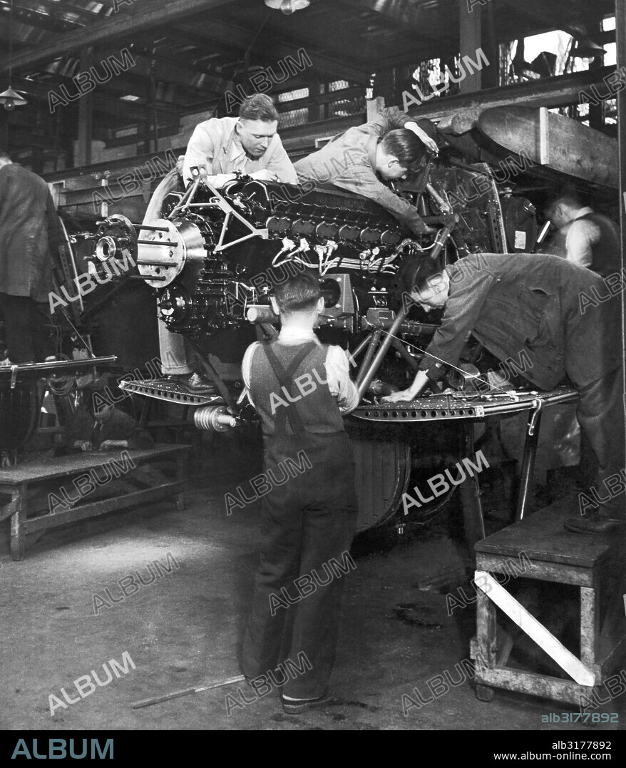 London, England:  c. 1936 Workers at Handley Page's Cricklewood works engaged in the government expansion mandate to triple the size of the Royal Air Force by March 31, 1937. Here the workers are assembling the engine mountings.   © Underwood Archives / The Image Works.