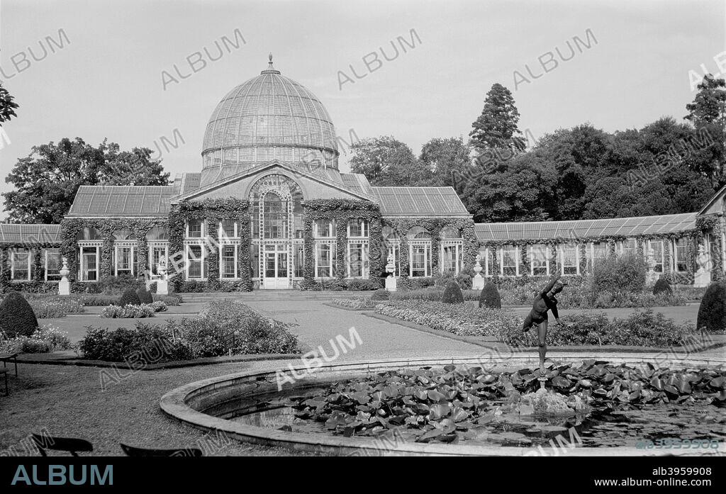 Conservatory at Syon House, Isleworth, London, c1945-c1965. A view of the conservatory and gardens at Syon House, Isleworth. Syon House has been the home of the Dukes of Northumberland since 1594.
