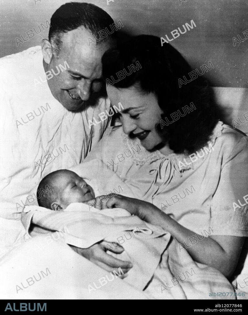 Hollywood , California : Olivia de Havilland and baby. Screen star Olivia de Havilland spent the better part of a year in bed awaiting the birth of her first child , and was rewarded on 27 September 1949 by the personal appearance of little Benjamin Briggs Goodrich ; Visitng the screen star at the Good Samaritan Hosptial is the proud father , Marcus Aurelius Goodrich , a noted author. 23 October 1949.