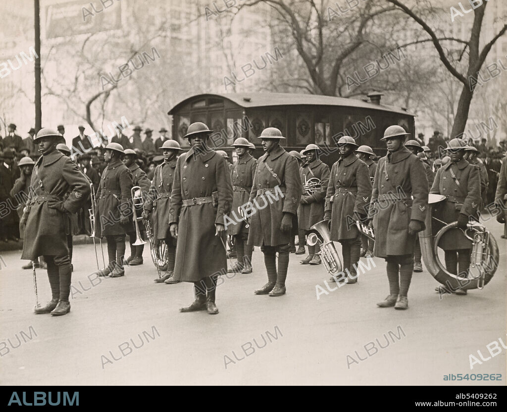 Lt. Europe and his Famous Jazz Band of the 369th Colored Infantry in parade on 5th Avenue. James Reese Europe (1881 - 1919) was an African-American ragtime and jazz arranger, composer and bandleader. During WWI he saw combat as a lieutenant with the 369th Infantry and led their regimental band. Paul Thompson, February 17, 1919 (cropped and cleaned).