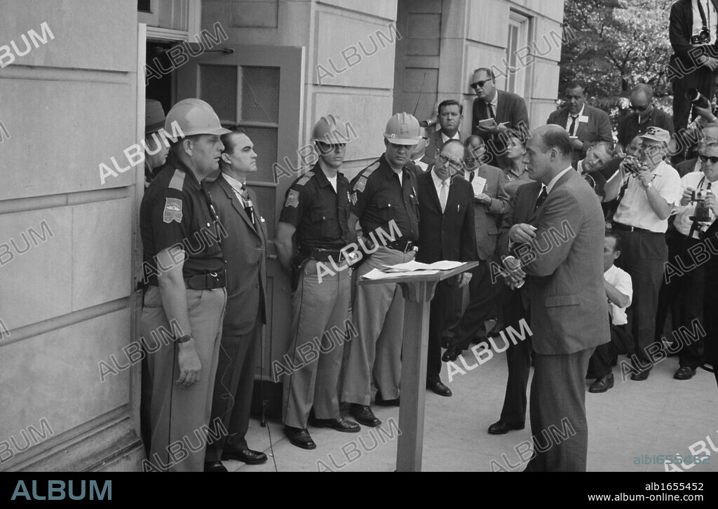 George Wallace (1919-1998) Governor of Alabama for four terms between 1963 and 1987. Wallace attempting to block integration at the University of Alabama, standing defiantly at a door while being confronted by US Deputy Attorney General Nicholas Katzenbach, 11 June 1963. Photographer: Warren K Leffler.