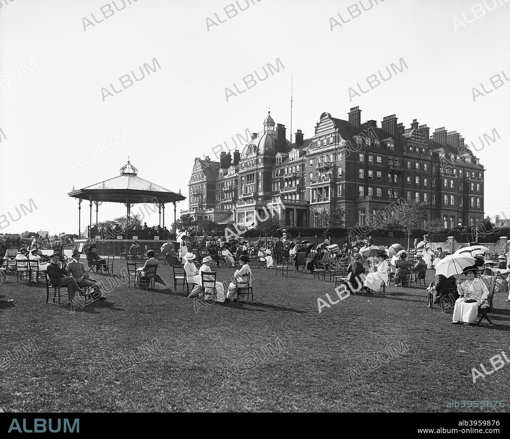 Hotel Metropole, Metropole Road East, The Leas, Folkestone, Kent, 1915. View from the south-east, with people in the foreground seated around the bandstand on The Leas.