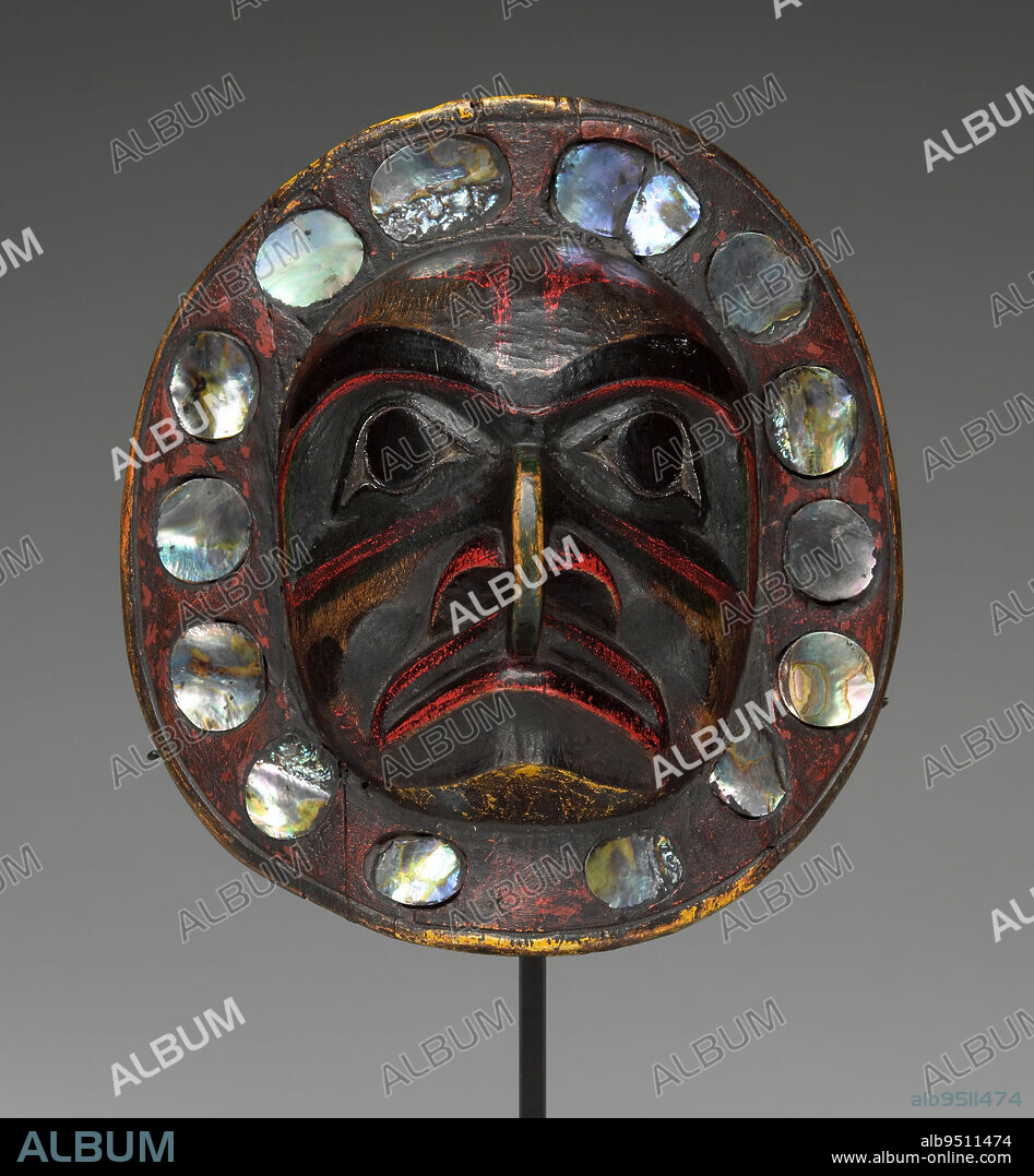 Frontlet, c. 1820, 3 3/8 x 7 1/4 x 7 13/16 in. (8.57 x 18.42 x 19.84 cm), Wood, abalone, pigment, hessian, resin, 19th century, Frontlets are masterpieces of Northwest Coast art, and many of the finest were produced by the Tsimshian. The frontlet formed part of an imposing decorative headdress worn by both men and women as the crowning feature of a ceremonial outfit that indicated wealth and status. This one is a rare, round example.The mask portrays a man transforming into a bird, perhaps an eagle, one of the four Tsimshian clans. Bright paint, now faded, is still visible on the mask's face, which is carved in this culture's classic early style. A border of shimmering abalone shell, a valuable item traded from California, rings the face. Together with its surrounding headdress, the frontlet produced an effect of great splendor.