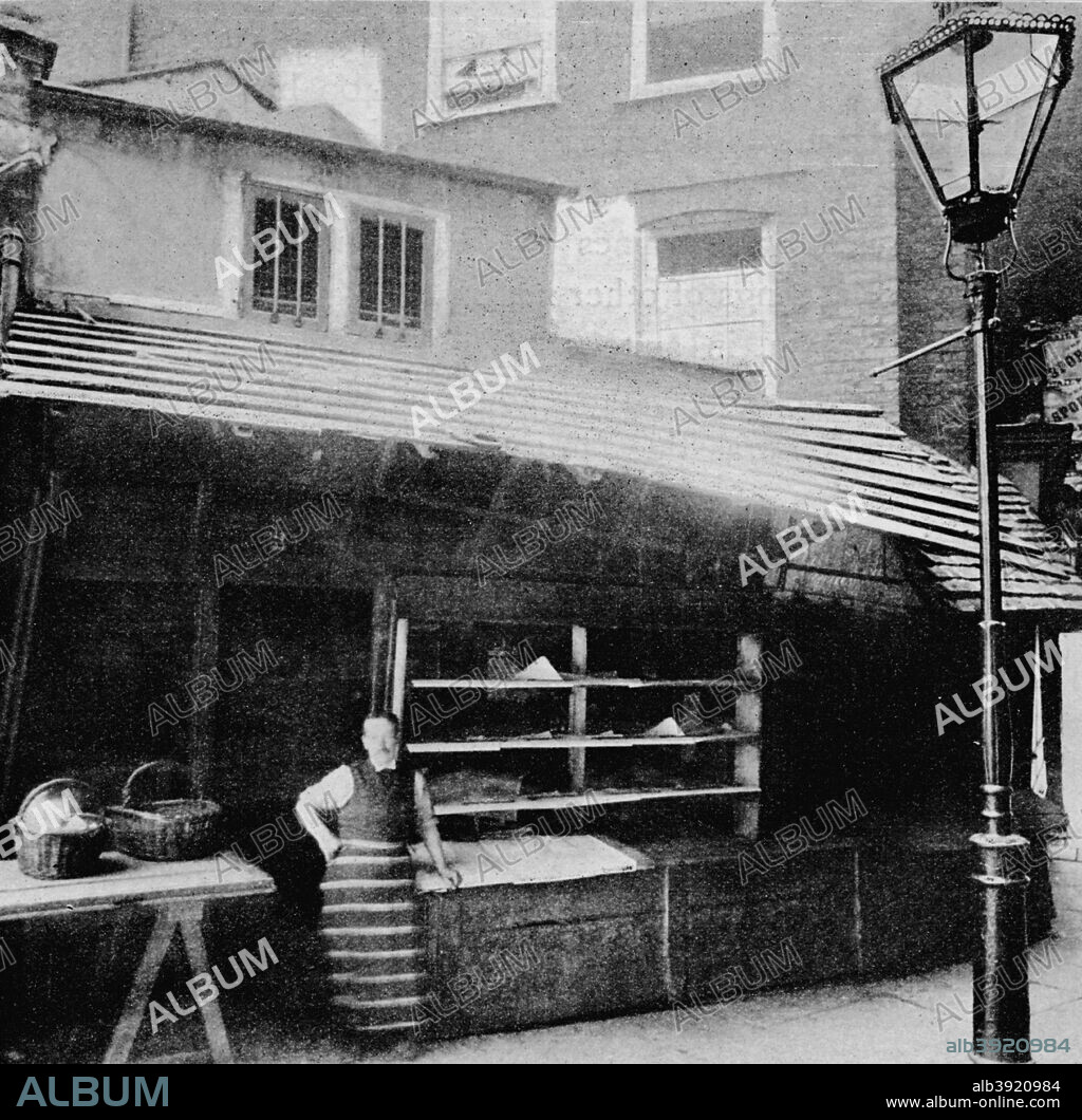 Shop and solar, Clare Market, London, since demolished, 1895 (1904). Clare Market was an area of London in the parish of St Clement Danes to the west of Lincoln's Inn Fields. Clare Market was originally centred on a small market building constructed by Lord Clare in c1657. From London in the Time of Tudors, by Sir Walter Besant. [Adam & Charles Black, London, 1904].