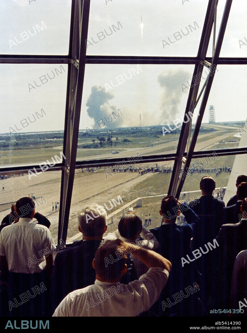 Personnel in the Launch Control Center watch the Apollo 11 liftoff from Launch Complex 39A at the start of the historic lunar landing mission. The Launch Control Center (LCC) is a four-story building at NASA's Kennedy Space Center on Merritt Island, Florida, used to manage launches of spacecraft from Kennedy Space Center Launch Complex 39. The LCC handles all American space flights with human crews. Attached to the southeast corner of the Vehicle Assembly Building, the LCC contains offices; telemetry, tracking, and instrumentation equipment; the automated Launch Processing System; and four firing rooms. LCC has conducted launches since the unmanned Apollo 4 launch in 1967. LCC's first launch with a human crew was Apollo 8 on December 21, 1968. NASA's Space Shuttle program also used LCC. NASA has renovated the center for the upcoming Space Launch System (SLS) missions, which are scheduled to begin in 2020 with Exploration Mission-1.