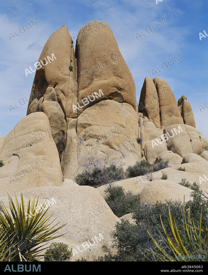 Vertical jointing in the monzogranite of Joshua Tree National Park, California. Spheroidal weathering rounds off the rocks. A thin aplite dike runs through the boulders.
