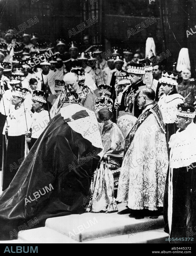 Romantic Moment in the abbey as the duke of Edinburgh places a lingering kiss of homage on the cheek of his wife, Queen Elizabeth, as she sits on her throne wearing St. Edward's crown. June 05, 1953. (Photo by Daily Mirror).
