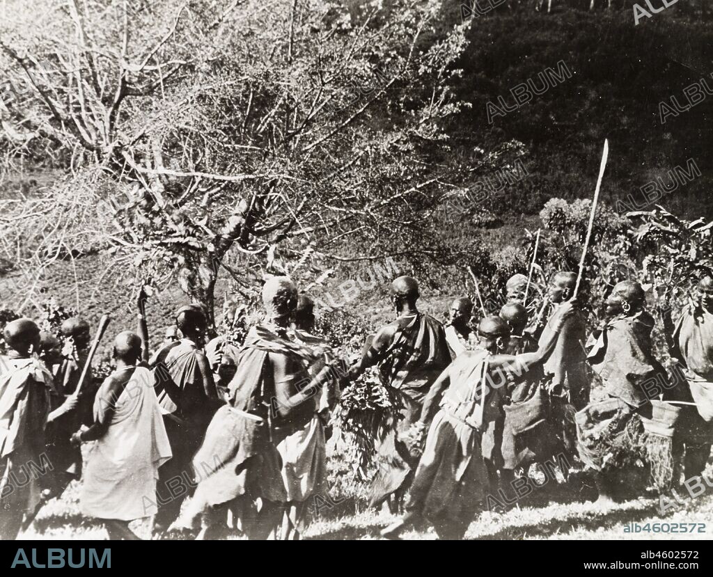 Kenya, Kikuyu women perform a ceremonial dance around a fig tree during an annual circumcision ritual marking the initiation of children into adulthood. Original manuscript caption:A circumcision: women dancing round the fig-treeSouth Nyeri 1936, 1937. 1995/076/1/2/5/27.
