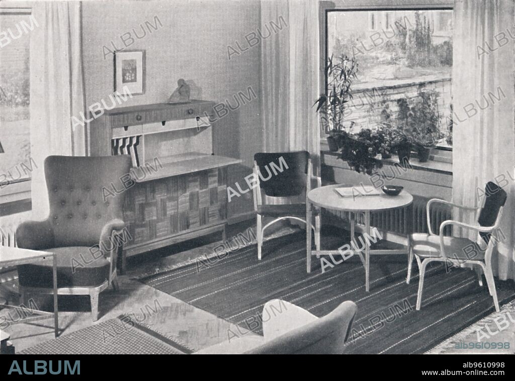 'A Swedish living-room with furniture designed by Caarl-Axel Acking and made by Svenska Mobelfabrikerna Bodafors. Textiles designed by Elsa Gullberg', c1945. From Decorative Art 1943-48 - The Studio Year Book . [The Studio Limited, London].