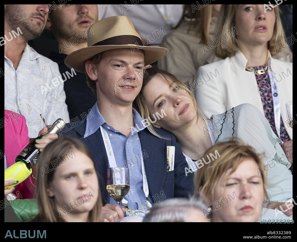 July 2, 2022, London, England: Wimbledon Day Six began on Saturday with a number of famous faces in the crowd. Among the glamorous stars of the sporting event were led by THOMAS BRODIE-SANGSTER, 32, and his stylish girlfriend TALULAH RILEY, 36 (the twice ex-Mrs. Musk). The pair cut a typically stylish figure as they took to Center Court in pastel ensembles. St. Trinians star Talulah looked effortlessly chic in a mint green maxi dress with a ruffled hem and collar, while lace embroidery adorned the center of the piece. She added a waist belt in the same color as the dress and added crossed black sandals. The beauty had her blonde locks swept away in a low ponytail, leaving two pieces to frame her face. Thomas looked dapper in soft beige trousers, adding a baby blue shirt to his summery smart look. With a navy blue blazer over it, the Love Actually actor added a nude fedora hat over his blonde tresses. (Credit Image: © Stephen Lock/i-Images via ZUMA Press).