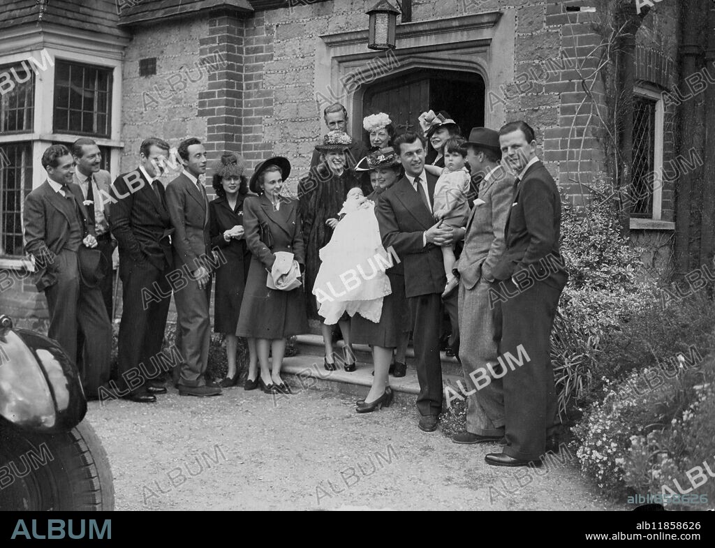 A huge crowd of film fans mobbed Stewart Granger and his wife at the picturesque Linchmere Church, Haslemere, where their baby daughter Lindsay was christened. Sally Gray was present as godmother to the child but James Mason and John Mills also godparents were unable to be there. Photo shows christianing group. Stewart Granger holding Lindsay with Mrs Granger surrounded by family and friends. 5 May 1946.