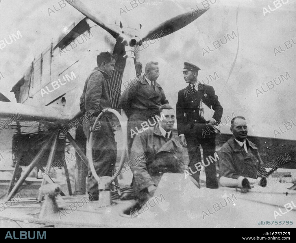 Von Gronau lands in labrador afterafter third flight across the Atlantic . Captain Wolfgang von Gronau , the famous German aviator , completed his third flight across the Atlantic from Germany to America via the Arctic route , when he and his companions landed at Cartwright Labrador . Left to right standing Franz Hack , mechanic , Fritz Albrecht , wireless operator , and a customs official seated , Gert von Roth , second pilot , and Captain Wolfgang von Gronau , on their landing after their flight across the Atlantic . 4 August 1932.