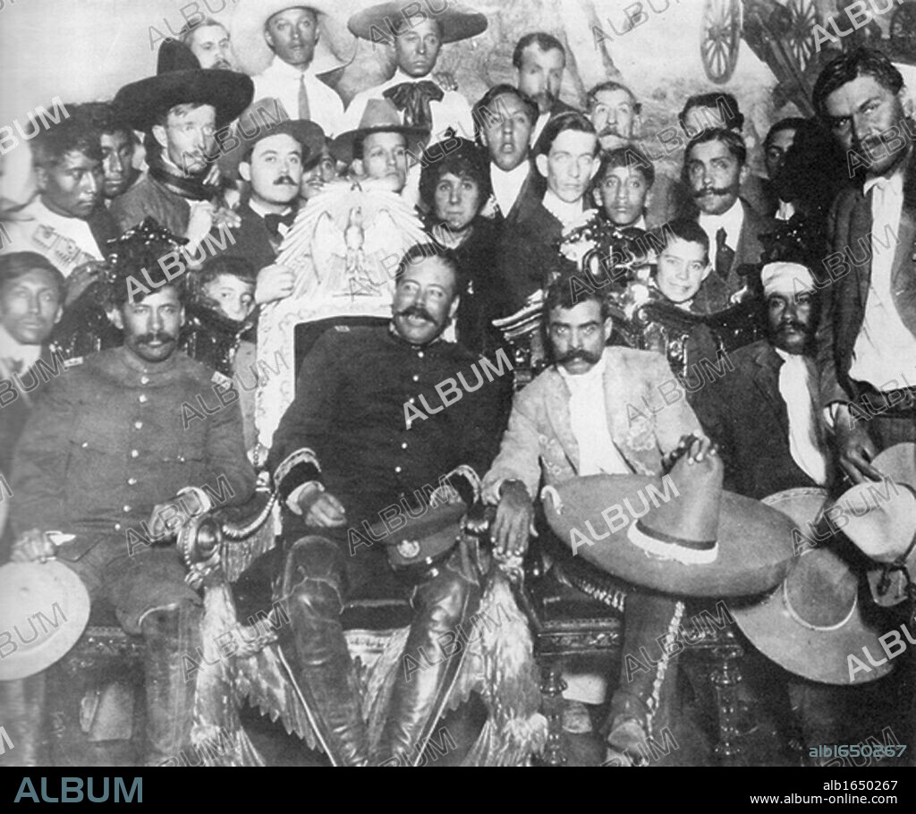 Mexican Revolution 1910-1913: Rodolfo Fierro (1880-1915) far right, stands by as Pancho Villa (in the Presidential chair) chats with Emiliano Zapata at Mexico City. Tomas Urbina is seated at far left, Otilio Montano (with his head bandaged) is seated to the far right.