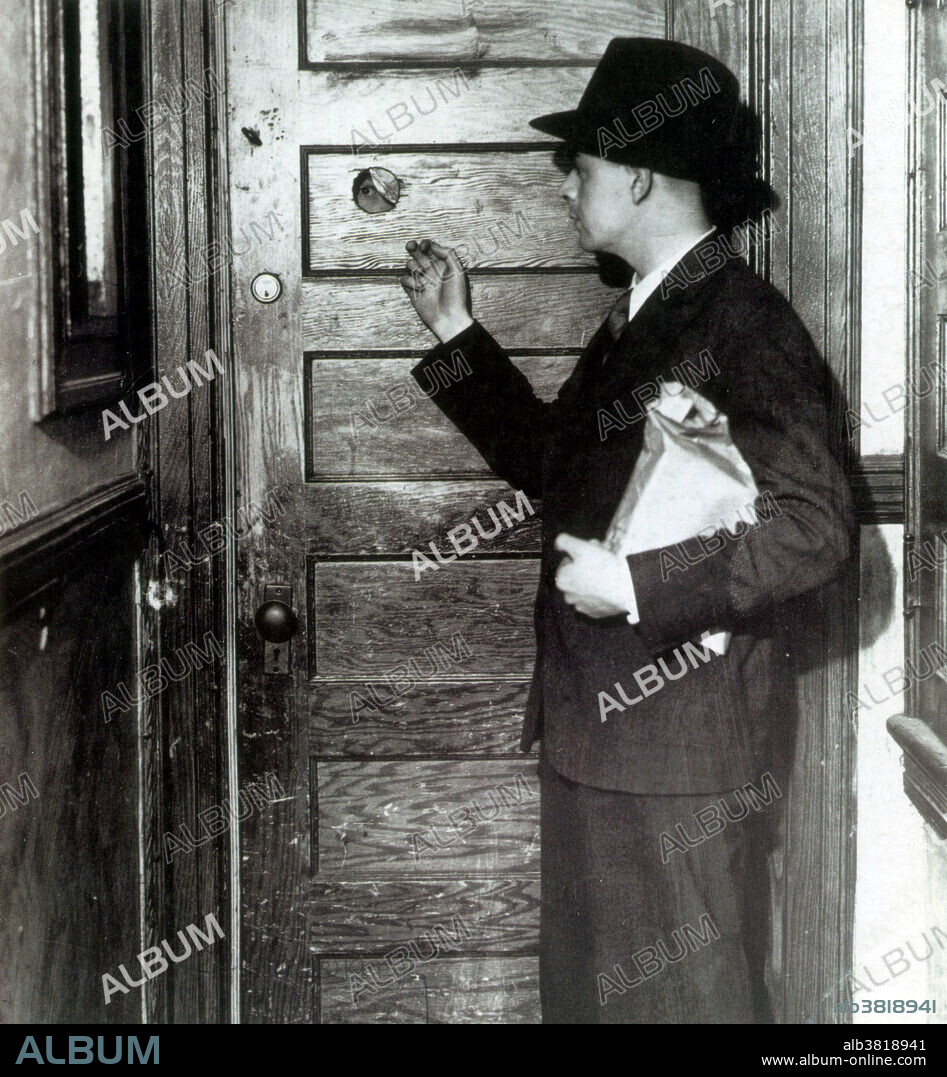 Editorial use only . A patron knocks at the door of a speakeasy. Note peephole in the door. A peephole allowed people inside the security of seeing outside without opening the door. Speakeasies were numerous and popular during the Prohibition years. Some of them were operated by people who were part of organized crime. Even though police and agents of the Bureau of Prohibition would often raid them and arrest their owners and patrons, they were so profitable that they continued to flourish. The speakeasy soon become one of the biggest parts of American culture during this time. Prohibition in the United States was a nationwide Constitutional ban on the sale, production, importation, and transportation of alcoholic beverages that remained in place from 1920 to 1933. Nationwide Prohibition ended with the ratification of the Twenty-first Amendment, which repealed the Eighteenth Amendment, on December 5, 1933.