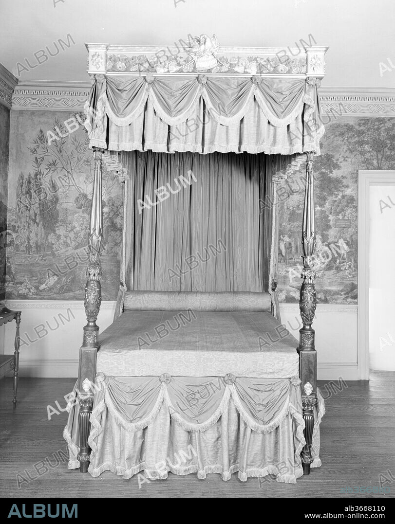 Bedstead. Culture: American. Decorator: Painting attributed to John Ritto Penniman (American, Milford, Massachusetts 1782-1841 Baltimore, Maryland); Carving attributed to Samuel McIntire (1757-1811); Carving attibuted to Thomas Wightman (American, active 1802-20 (?)). Dimensions: 106 3/4 x 58 5/8 x 79 1/2 in. (271.1 x 148.9 x 201.9 cm). Maker: Possibly by Thomas Seymour (1771-1848); Cornice attributed to John Doggett (1780-1857). Date: 1810-15.
According to the most recent scholarship on Thomas Seymour, there is no Boston carving of the Federal period more spectacular than the lavish decoration on the footposts of this bedstead carved by Thomas Wightman. Wightman is documented as working as a sub-contractor for Thomas Seymour in 1809 on an order of furniture for Elizabeth Derby West (1762-1814) for Oak Hill, her country estate in Danvers, Massachusetts.