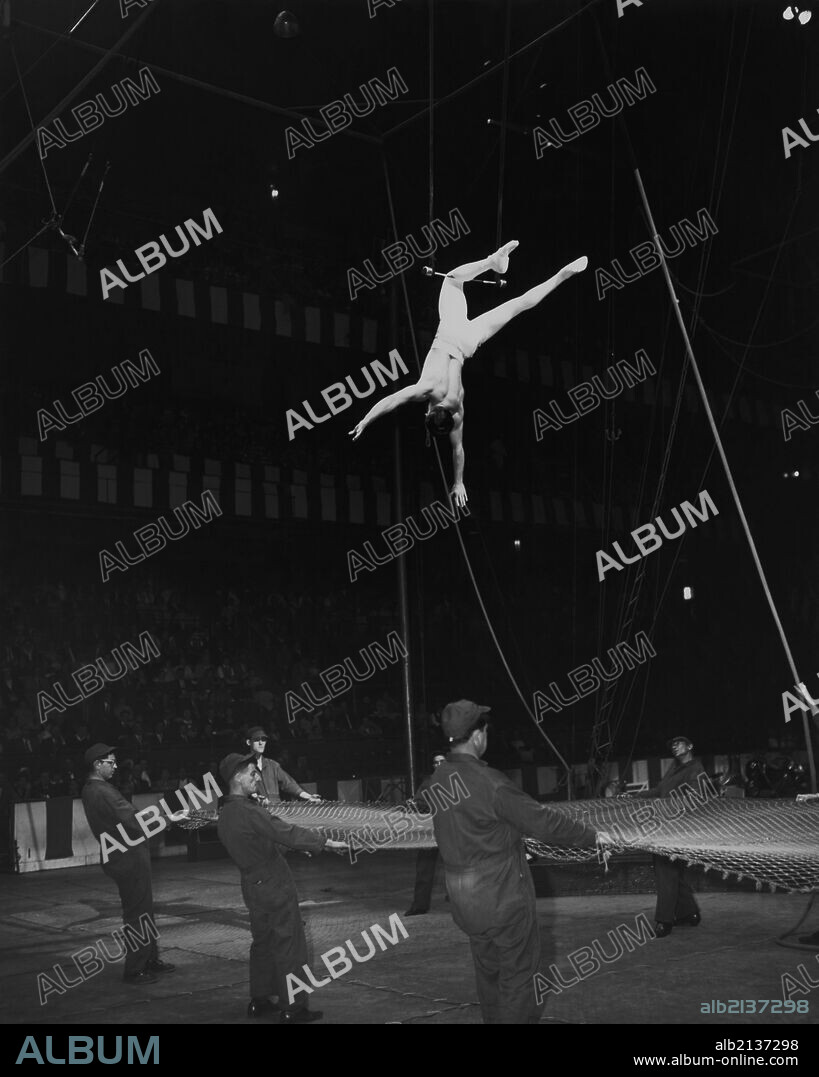 Trapeze artist above safety net.