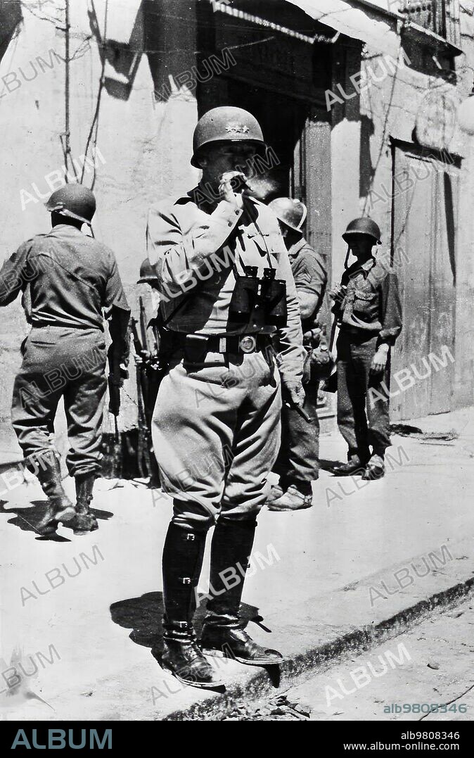September 1943. An American leader in Sicily.- Lieutenant General Patton, Defense of the 7th American Army in Sicily, smoking a cigar on a street in Hela, while watching the North American Troops advance.