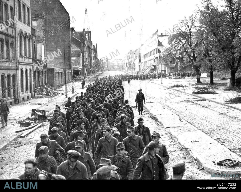 Nazis Surrender Aachen German solders fill the street of Aachen as they are marched to a prisoner-o-war enclosure following the formal surrender of the German city by Colonel Gerhard Wilck, commander of the Nazi forces, October ***** 1994, to the First U.S. Army. The entire ***** of 2,500 was captured ***** the Germans' refusal of the "Surren ***** ultimatum delivered by the American forces October 10, 1944. November 19, 1944. (Photo by Keystone Photo).