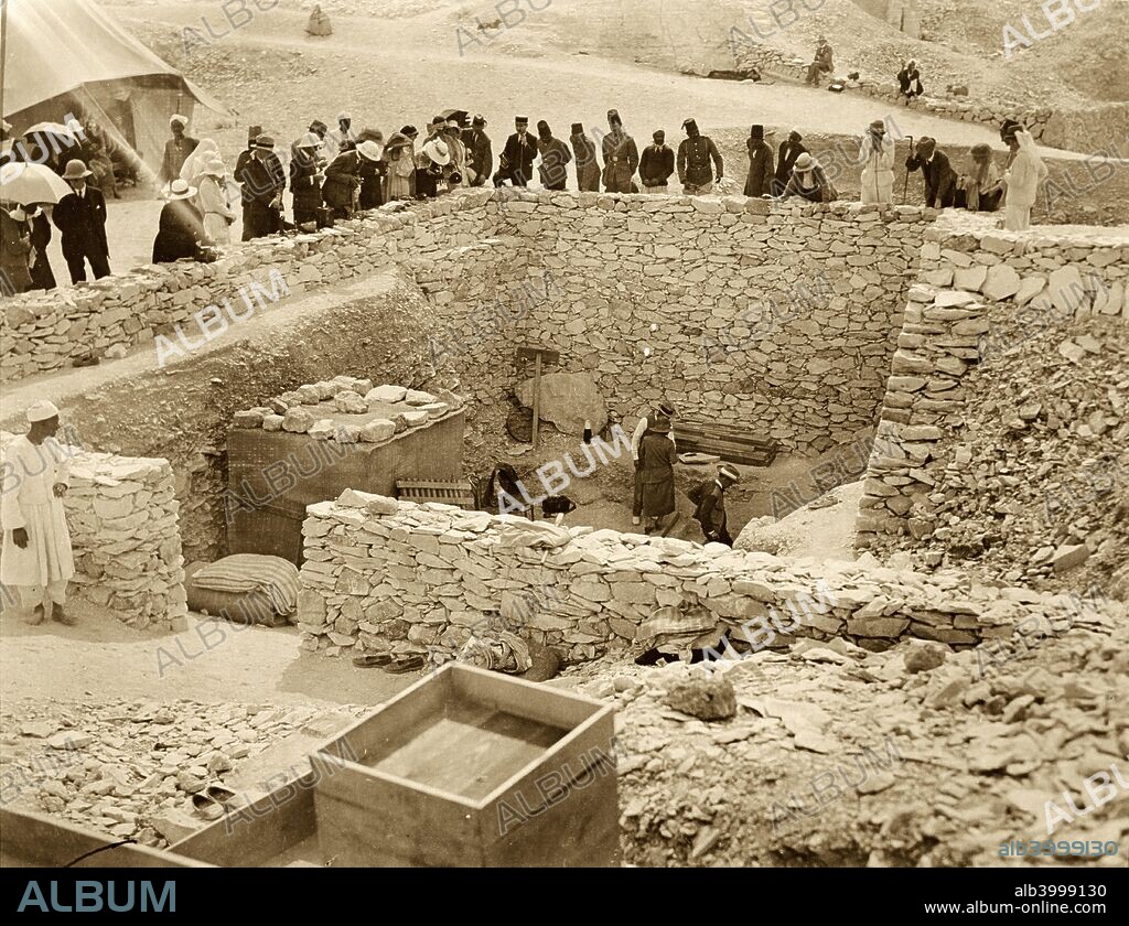 Outside the tomb of Tutankhamun, Valley of the Kings, Egypt, 1922. Lord Carnavon (1866-1923), his daughter Lady Evelyn Herbert, and archaeologist Howard Carter (1874-1939) at the entrance to the tomb. Lord Carnarvon was Carter's financial backer in his excavations in the Valley of the Kings. The discovery of Tutankhamun's tomb in 1922 was one of the most astounding discoveries in archaeology. Tutankhamun was a previously unknown pharaoh whose name had been eradicated from historical records by one of his successors because of his association with the heretical pharaoh Akhenaten, who was Tutankhamun's father-in-law. Consequently his tomb, uniquely, had remained undisturbed by grave robbers.