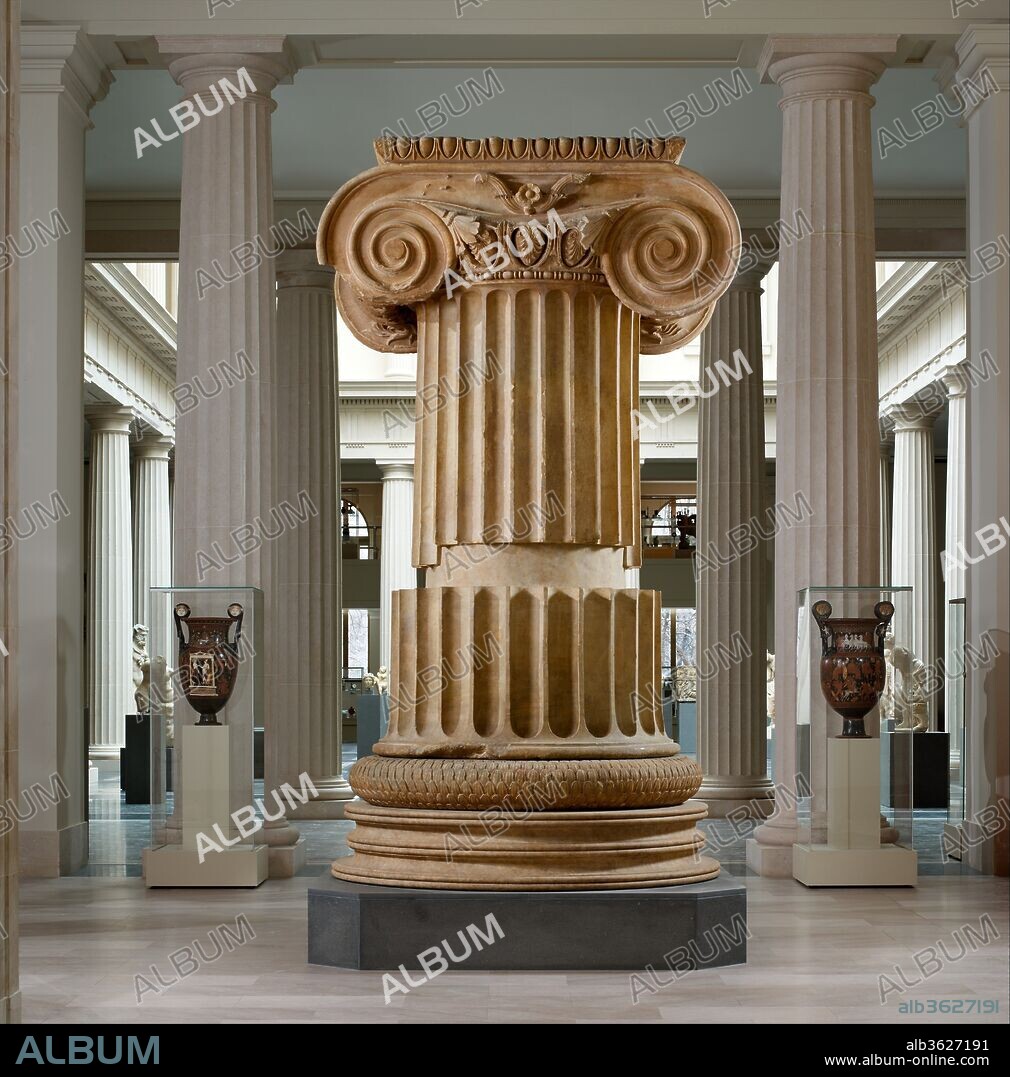 Marble column from the Temple of Artemis at Sardis. Culture: Greek. Dimensions: H. 142 1/8 in. (361 cm). Date: ca. 300 B.C..
The section of a fluted Ionic column in the center of this room stood over fifty-eight feet high in its original location at the Temple of Artemis. The delicate foliate carving on the capital is unique among extant capitals from the temple, and the torus (foliated base), with its vegetal scale-like pattern, is also exceptionally elaborate. This capital is slightly smaller than others found at the site, indicating that it does not belong to the outer colonnade. Two similar pairs of columns (marked in red on the plan shown nearby) stood in the east and west porches. The column, displayed here with most of the shaft omitted, was probably originally from one or more of those pairs. Alternatively, it may be from the cella (inner room) or from the inner back porch. Parts of the fluted shaft are restored, and the profiled base below the torus is a copy of the original.