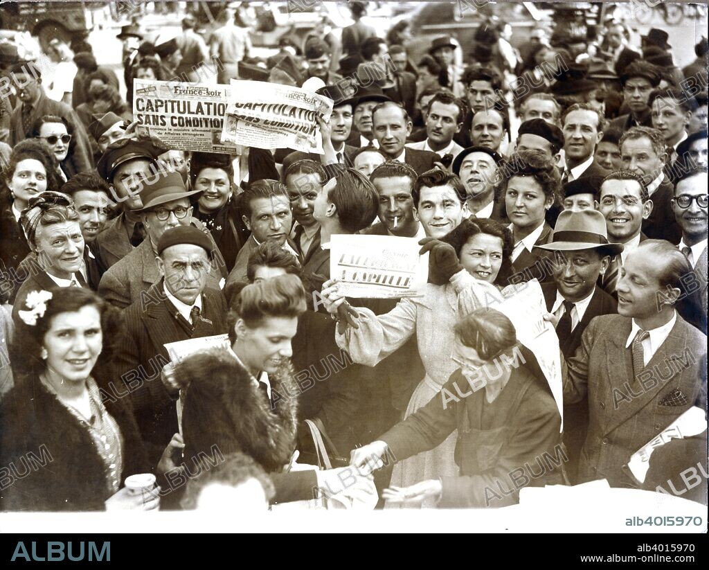 VE day celebrations, Paris, 8 May 1945. Jubilant French citizens holding up newspapers reporting the unconditional surrender of Nazi Germany.