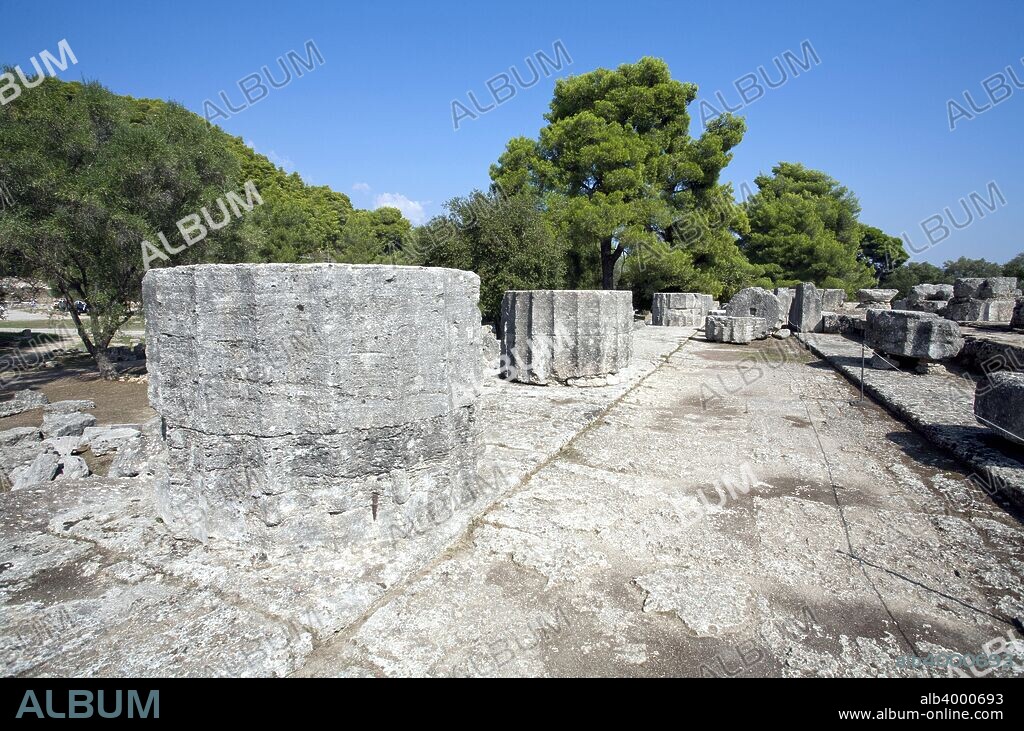 The Temple of Zeus at Olympia, Greece. The Temple of Zeus was a Doric peripteral building with 6x13 columns built between 470 and 456 BC. It was the work of Libon, an architect from Elis. The largest temple in the Peloponnese, it was considered the perfect expression of the Doric temple. Today, only column bases and tumbled sections remain. Olympia, a sanctuary of ancient Greece, is probably best known for having been the site of the Olympic Games in classical times.