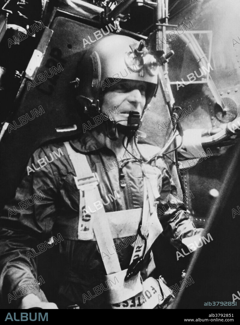 Astronaut Carpenter shown training in a centrifuge, his face distorted by the enormous g-force pressure.
