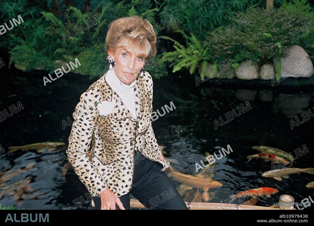 Wife Elisabeth (Lippens) of Prince Ferdinand von Bismarck poses in front of a koi carp pond in the garden of the family residence of Bismarck's Schloss Friedrichsruh near Hamburg, Germany 2006.