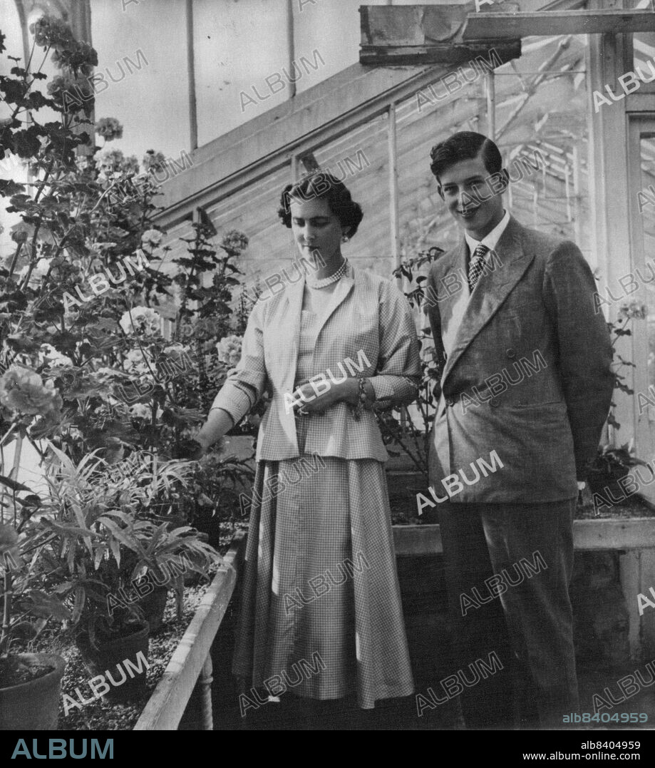 Royalty Fly To Malaya Today: The Duchess of Kent and her son, the sixteen-year-old second Duke of Kent, are seen in the Greenhouse of the Duchess' home Coppins, Iver, Buckinghamshire, in this new picture by Cecil Beaton.The Duchess and the Duke fly to Singapore today, September 27, to begin the first visit by a crown emissary to the far east for 30 years. September 26, 1952. (Photo by Associated Press Photo).