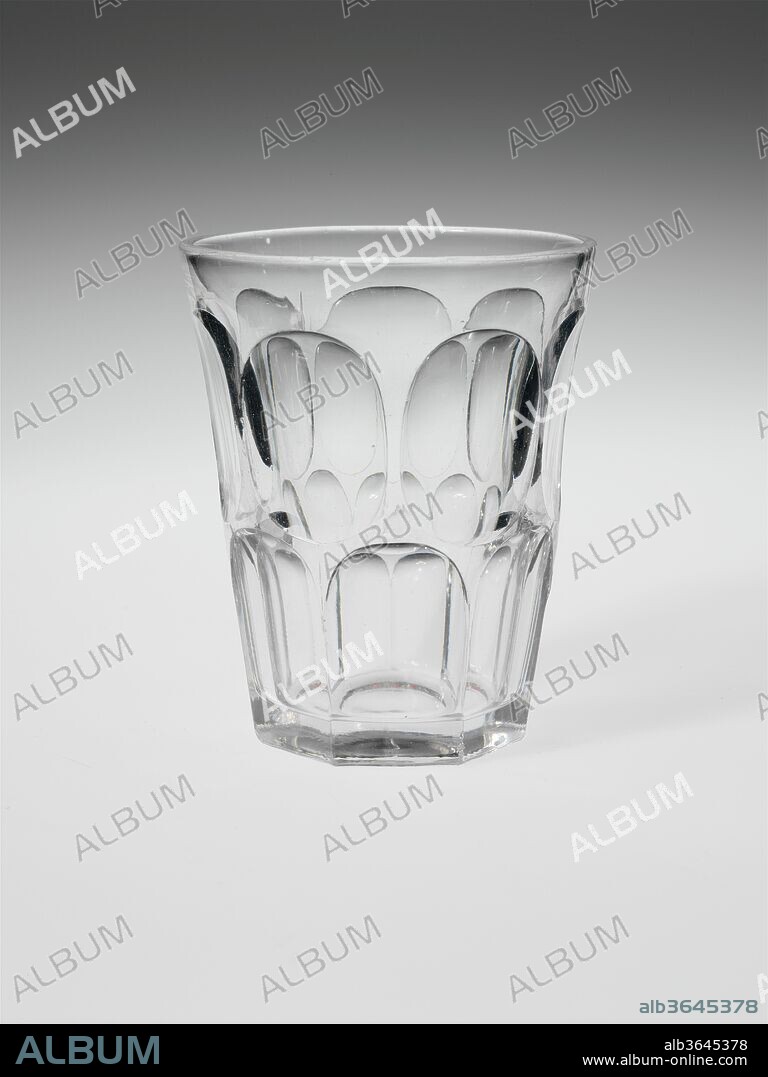 Flip Glass. Culture: American. Dimensions: H. 4 9/16 in. (11.6 cm); Diam. 3 3/4 in. (9.5 cm). Date: 1830-70.
With the development of new formulas and techniques, glass-pressing technology had improved markedly by the late 1840s. By this time, pressed tablewares were being produced in large matching sets and innumerable forms. During the mid-1850s, colorless glass and simple geometric patterns dominated. Catering to the demand for moderately-priced dining wares, the glass industry in the United States expanded widely, and numerous factories supplied less expensive pressed glassware to the growing market. At the Exhibition of the Industry of All Nations at New York's Crystal Palace in 1853, for example, the New England Glass Company exhibited 130 pieces of one design, "consisting of bowls, tumblers, champagnes, wines, and jelly glasses." This object belongs to one such service. Although the glass manufactory is not known, the glassware is very typical of the large services that were very popular with America's middle class in the nineteenth century.