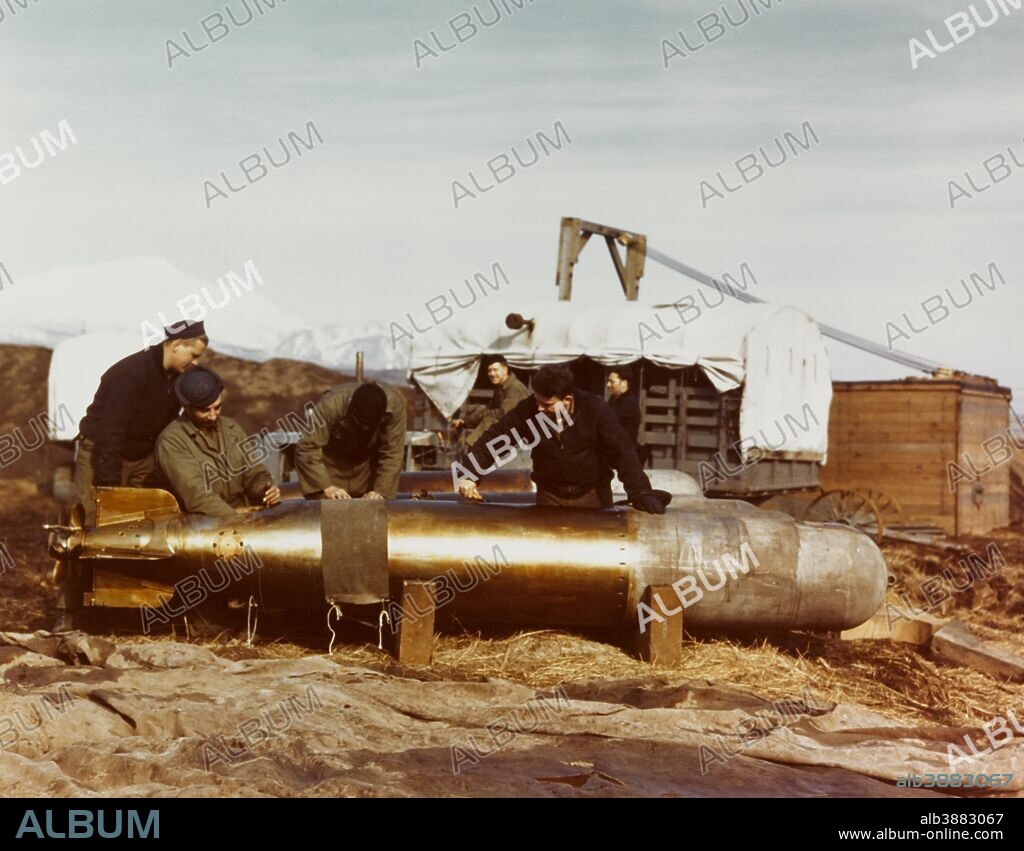 Mark 13 torpedo is serviced by Navy ordnancemen at an Aleutians air station, circa 1943.