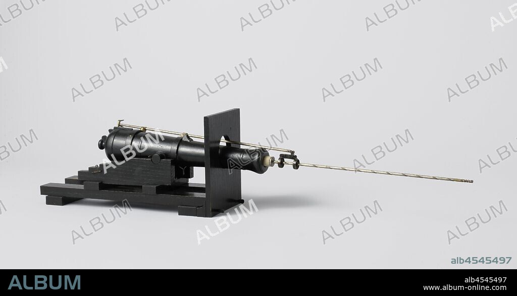 Model of a 60-Pounder Muzzle-Loading Gun with Loading Gear, Model of a long cannon of 60 pounds on a sliding carriage, with a new design of loading equipment, on ship part with artillery gate, incomplete. The model is, except for some metal parts, completely painted black. The wooden barrel is 35.8 cm long and has a caliber of 20.5 mm, it is provided with a lock elevation and a visor holder on the tap piece. The body consists of two cheeks with four steps, connected by two axle bodies without wheels, and a soleplate. The gun gate is oval. The loading equipment is attached to the barrel with brackets: it consists of a wiper with a handle that passes through two guides at the end of a long rod. A spiral-shaped groove is provided in the handle, into which a rope is laid which gives the wiper the rotating movement. This rod is attached to the bar on the barrel and has handles at the back with which the wiper can be brought directly in front of the mouth by turning, or next to the cannon so that it can be brought in through the gun gate. The hoist, which must run over three eyes at the guides on the rod, and other parts with which the wiper must be operated, are missing. 1:10 scale (Obreen)., van de Weetering, Netherlands, 1863, wood (plant material), brass (alloy), iron (metal), textile materials, h 18.5 cm × w 37.5 cm × d 13.7 cm × c 20.5 mm × h 25 cm w 58.5 cm × d 33 cm, F.L. Geerling designed this loading gear for the new armored defense vessels in 1863, keeping the gun gate as small as possible to protect the men from enemy fire. The design was tested on August 22, and although much criticism was expressed, it was recommended for further development. Geerling was asked to make improvements to the design, and it was tested again in 1864. Because the manageability was not significantly improved, further tests were stopped in 1865.