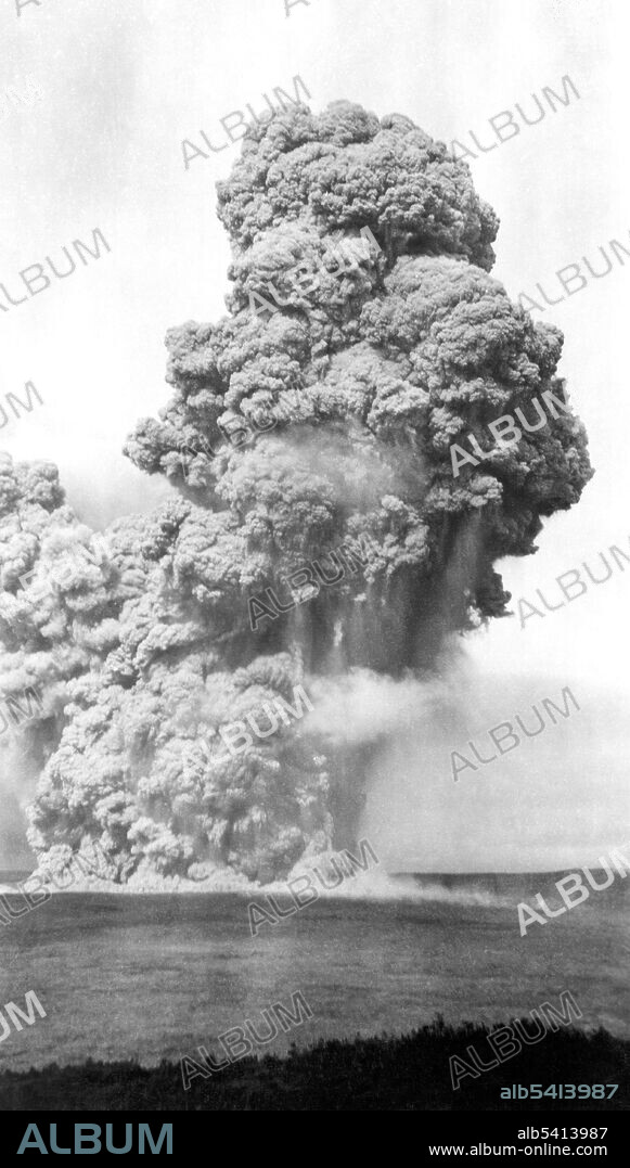 Halemaumau Crater, viewed from the Hawaiian Volcano Observatory, during the May 1924 eruption of Kilauea Volcano. The cloud is 8,000 feet high and rising at 17 feet per second at 8:14 a.m., May 22, 1924.