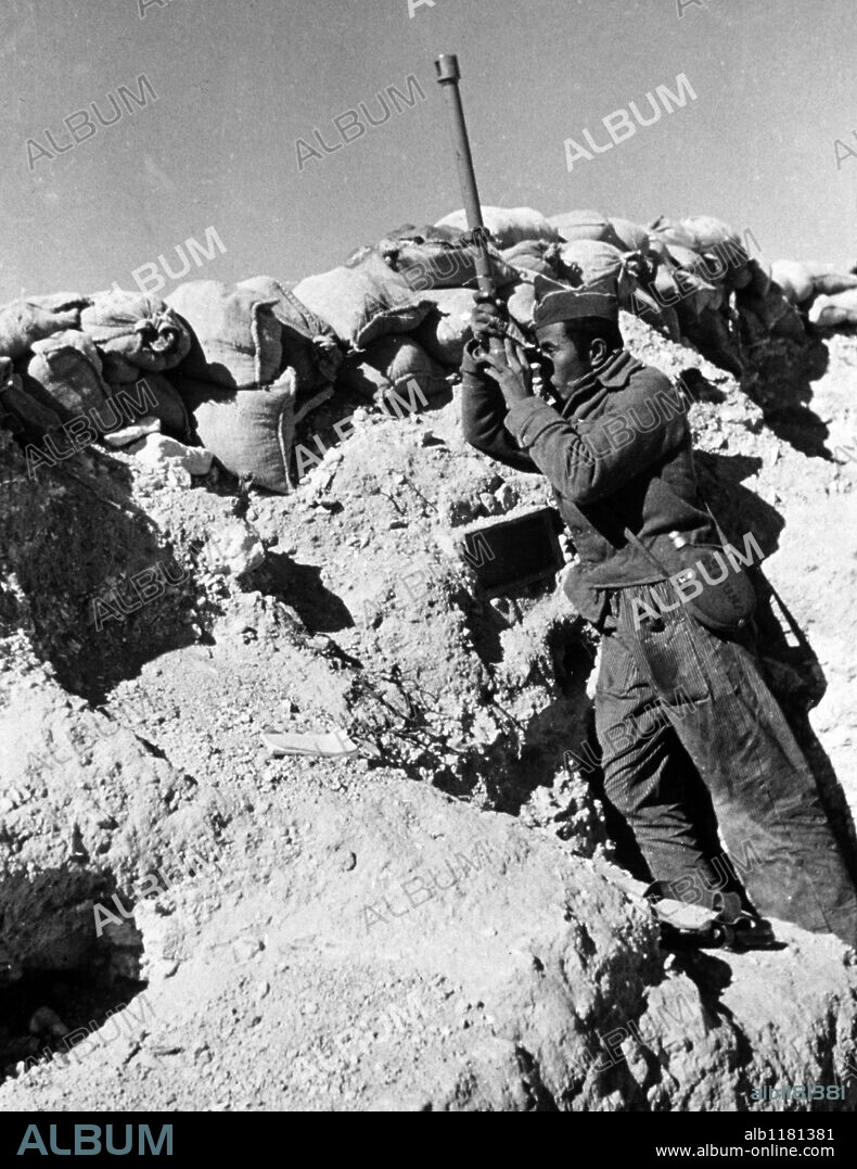 Spanish Civil War. American volunteer on look-out with periscope in front line trenches.