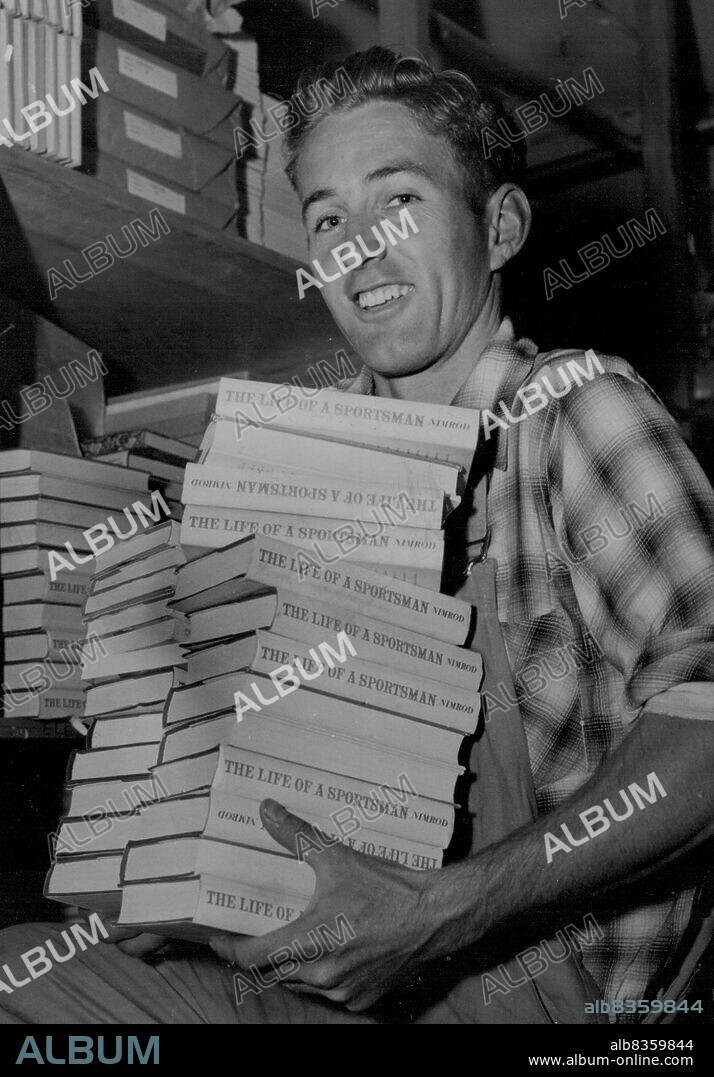 Melbourne's "flying milkman", record- breaking distance runner Dave Stephens, is no longer a milkman. Picture shows him at his new job in a bookstore. Stephens works part time and spends the rest of the day studying, hoping to become a schoolteacher. March 29, 1955.
