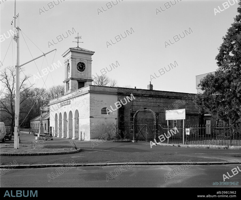 St George Barracks North, Weevil Lane, Gosport, Hampshire, 2000. The barracks were built in 1857-9. The guard house has an arched colonnade and an italianate clock turret. Two old ship's cannon guard the entrance and a complex flagpole stands on the green in front of the building.